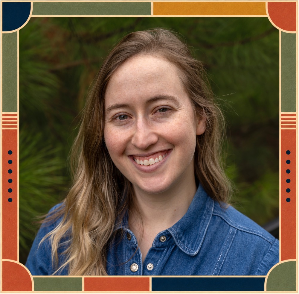 Portrait of Mallory J. Feldman, smiling outdoors in front of pine branches, in a decorative frame.